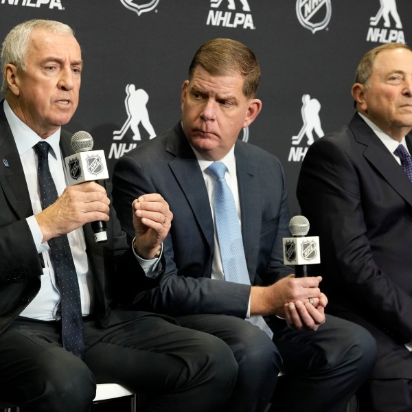 FILE - IIHF president Luc Tardif, left to right, NHLPA Executive Director Marty Walsh and NHL Commissioner Gary Bettman attend a news conference in Toronto, Feb. 2, 2024. (Frank Gunn/The Canadian Press via AP, File)