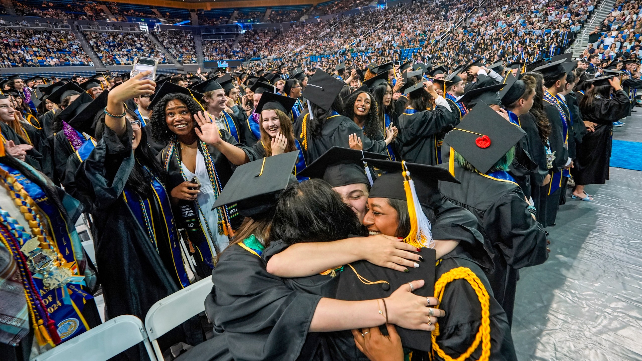 FILE - UCLA students celebrate during a commencement ceremony inside Pauley Pavilion on UCLA campus, in Los Angeles, June 14, 2024. (AP Photo/Damian Dovarganes, File)