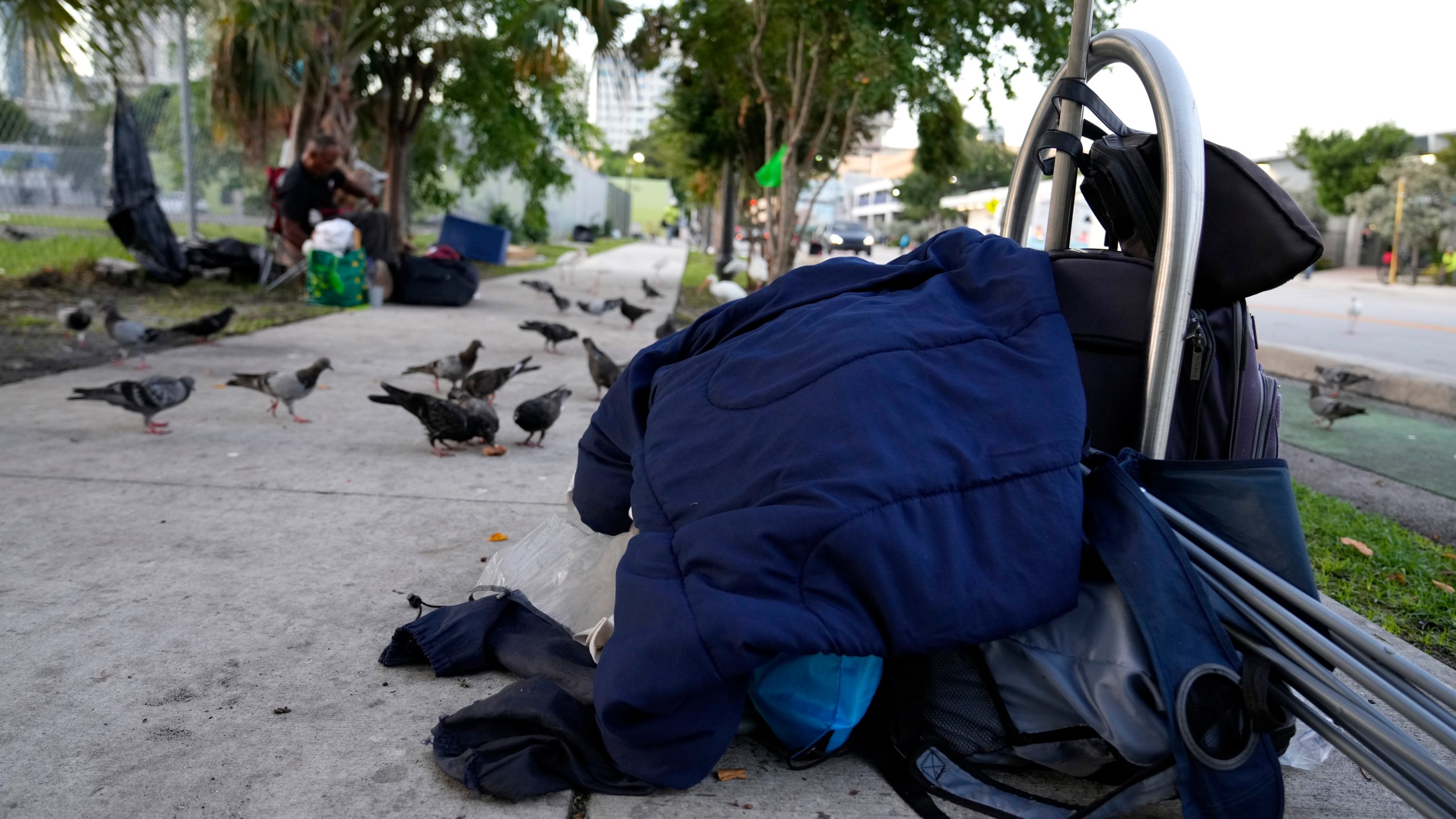 The belongings of a homeless person are piled on the sidewalk on the first day of a statute that took effect, making it illegal in Florida to sleep on sidewalks, in parks, on beaches or in other public spaces — one of the country's strictest anti-homelessness laws, Tuesday, Oct. 1, 2024, in Fort Lauderdale, Fla. (AP Photo/Lynne Sladky)