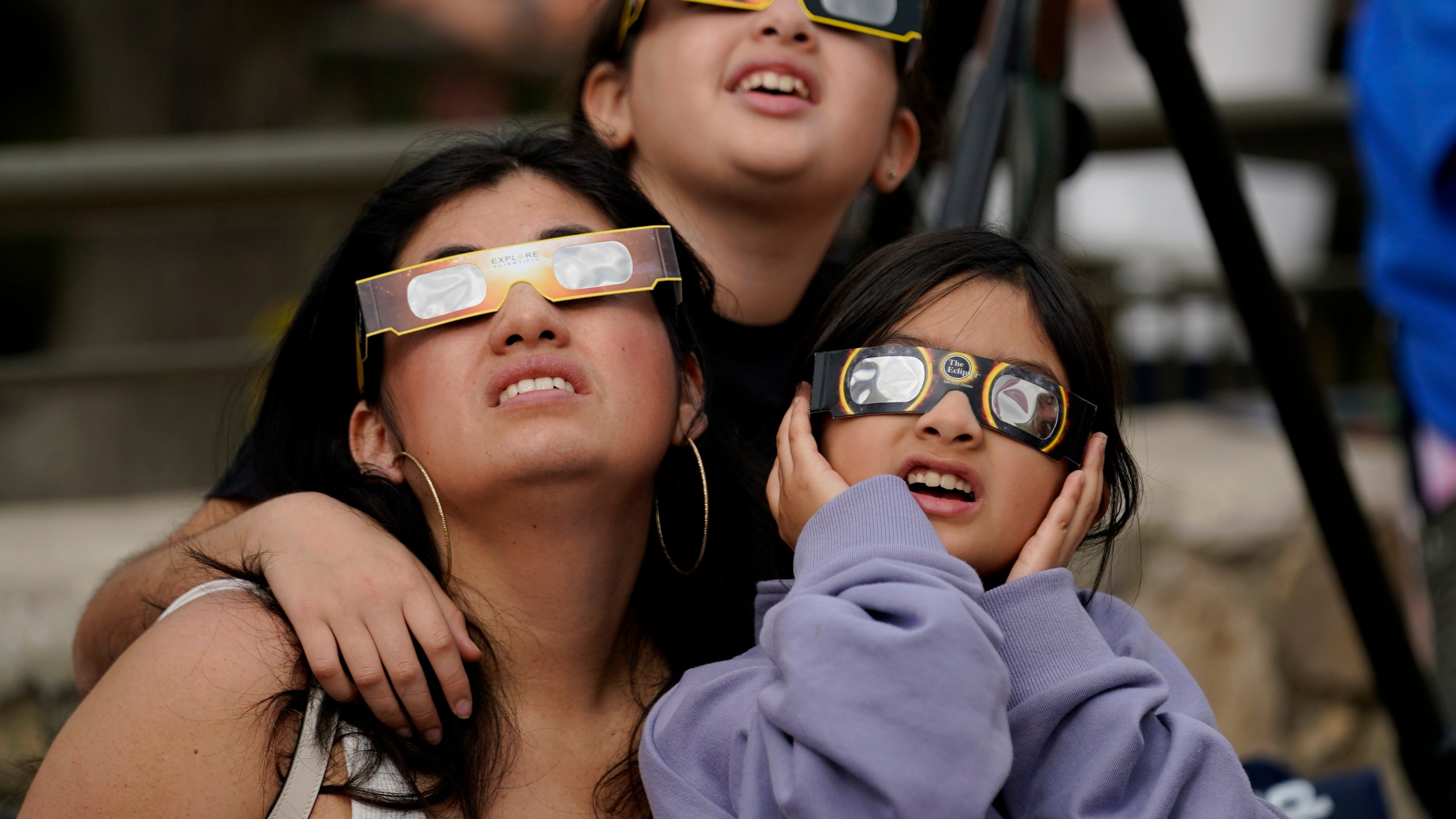 FILE - Viewers use special glasses to watch as the moon moves in front of the sun during an annular solar eclipse, or ring of fire, Saturday, Oct. 14, 2023, as seen from San Antonio. (AP Photo/Eric Gay, File)