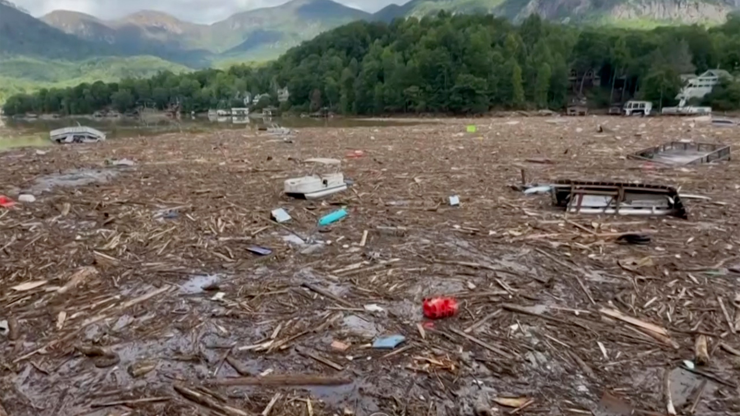 Flood debris from Hurricane Helene floats by in Rutherford County, N.C., Sunday, Sept. 29, 2024. (Tariq Bokhari via AP)