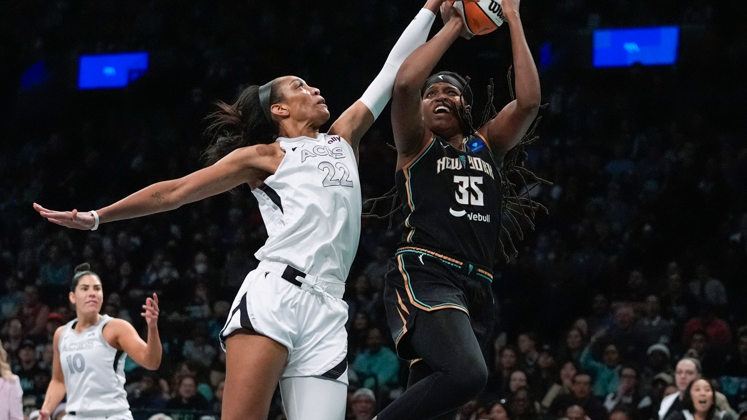 Las Vegas Aces' A'ja Wilson (22) defends a shot by New York Liberty's Jonquel Jones (35) during the first half of a WNBA basketball semifinal game, Tuesday, Oct. 1, 2024, in New York. (AP Photo/Frank Franklin II)