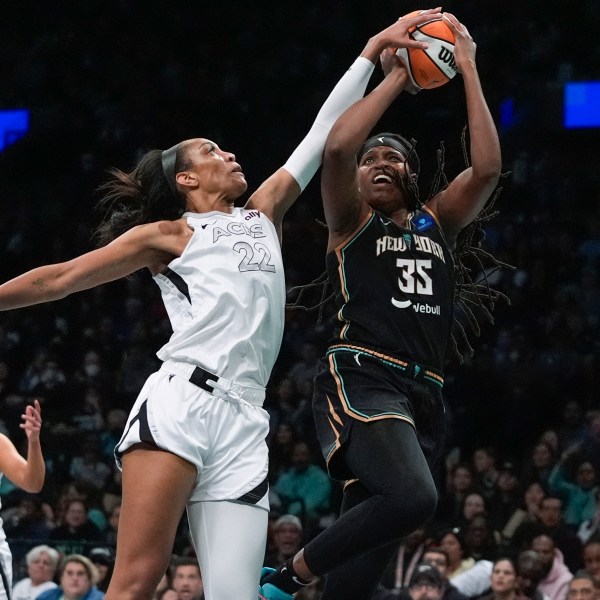 Las Vegas Aces' A'ja Wilson (22) defends a shot by New York Liberty's Jonquel Jones (35) during the first half of a WNBA basketball semifinal game, Tuesday, Oct. 1, 2024, in New York. (AP Photo/Frank Franklin II)