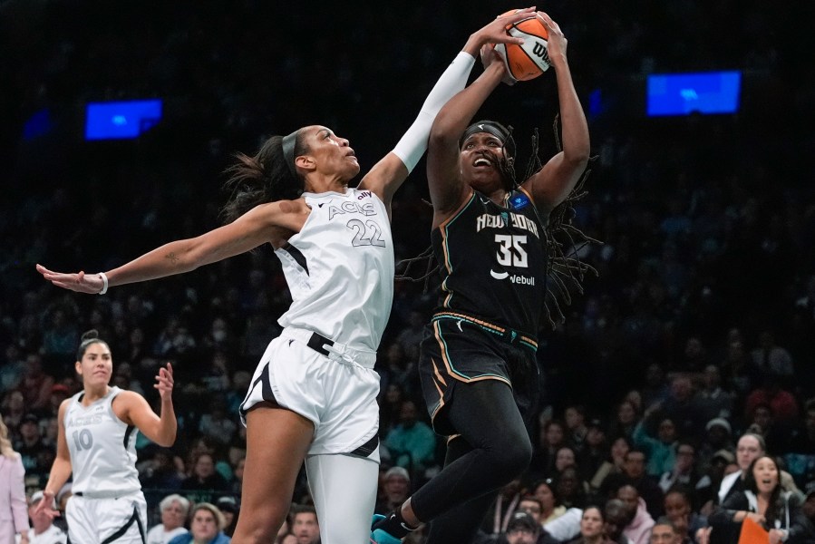 Las Vegas Aces' A'ja Wilson (22) defends a shot by New York Liberty's Jonquel Jones (35) during the first half of a WNBA basketball semifinal game, Tuesday, Oct. 1, 2024, in New York. (AP Photo/Frank Franklin II)