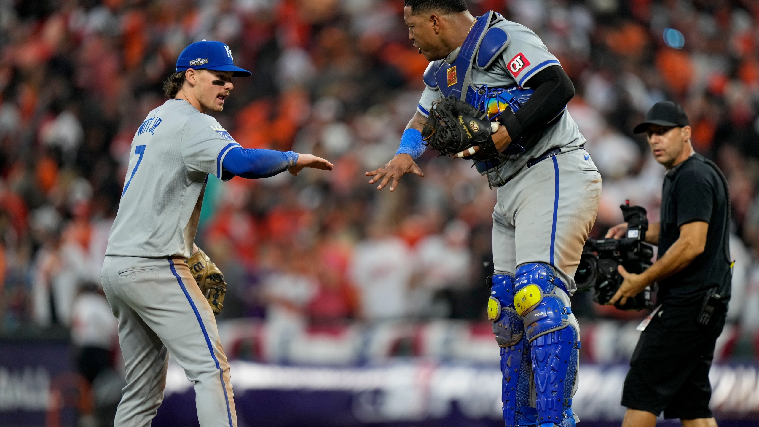 Kansas City Royals shortstop Bobby Witt Jr. (7) and catcher Salvador Perez celebrate their team's win over the Baltimore Orioles after Game 1 of an AL Wild Card Series baseball game, Tuesday, Oct. 1, 2024, in Baltimore. (AP Photo/Stephanie Scarbrough)