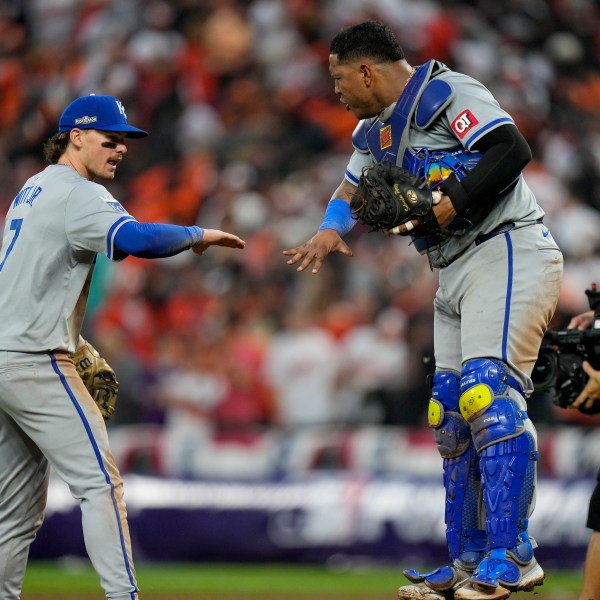 Kansas City Royals shortstop Bobby Witt Jr. (7) and catcher Salvador Perez celebrate their team's win over the Baltimore Orioles after Game 1 of an AL Wild Card Series baseball game, Tuesday, Oct. 1, 2024, in Baltimore. (AP Photo/Stephanie Scarbrough)