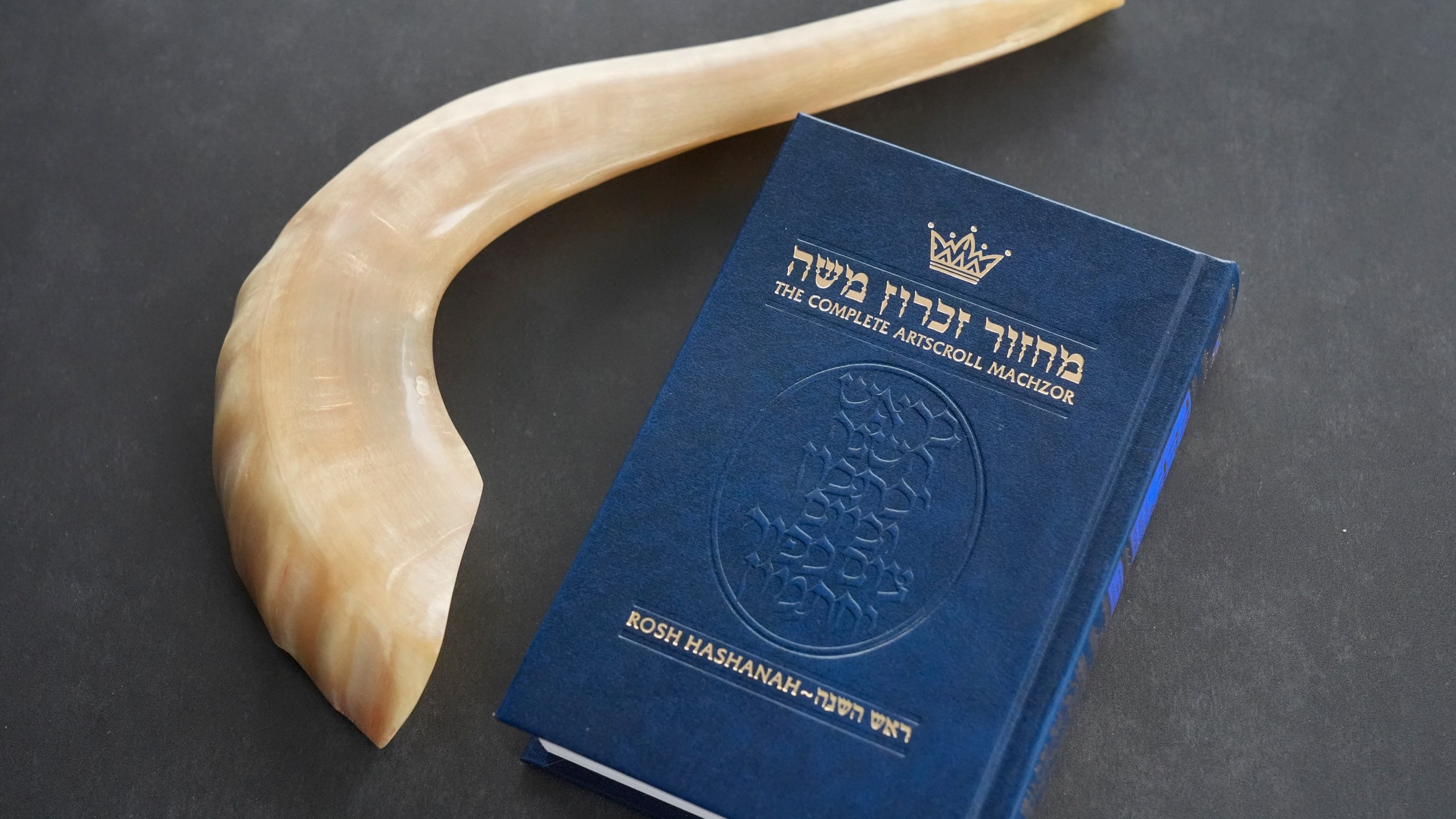 A shofar and a prayer book that Daniel Gammerman will use to privately celebrate the Jewish High Holy Days at home, are shown, Thursday, Sept. 26, 2024, in Miami. (AP Photo/Wilfredo Lee)