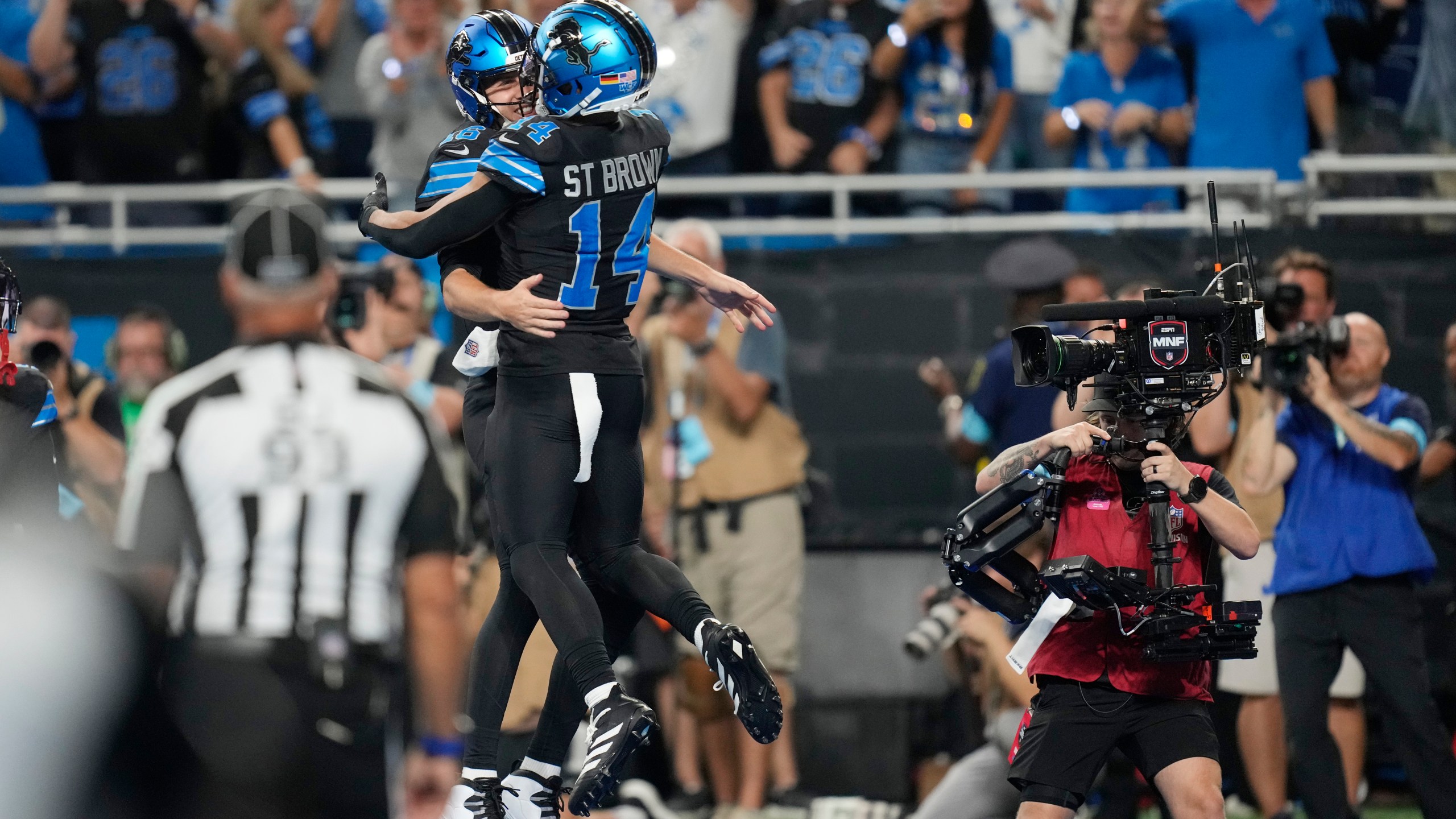 Detroit Lions quarterback Jared Goff, left, celebrates his rushing touchdown with teammate Amon-Ra St. Brown, who threw to Goff, during the second half of an NFL football game against the Seattle Seahawks, Monday, Sept. 30, 2024, in Detroit. (AP Photo/Paul Sancya)