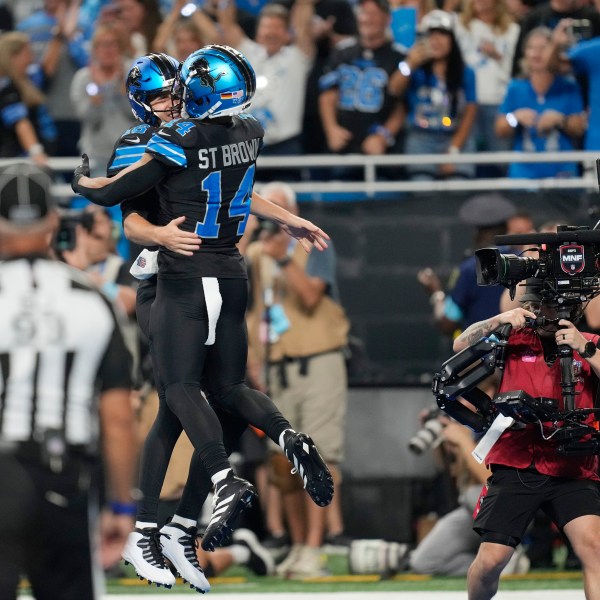 Detroit Lions quarterback Jared Goff, left, celebrates his rushing touchdown with teammate Amon-Ra St. Brown, who threw to Goff, during the second half of an NFL football game against the Seattle Seahawks, Monday, Sept. 30, 2024, in Detroit. (AP Photo/Paul Sancya)