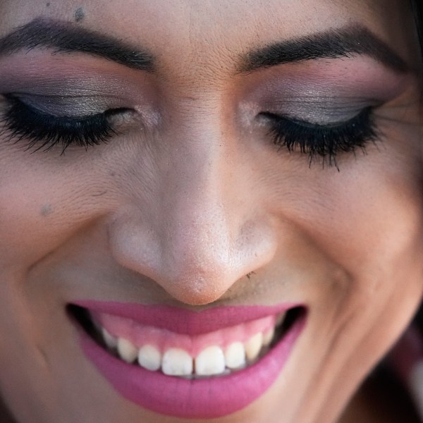 Julieth Luna Garcia, a transgender woman from El Salvador, smiles as she listens to Drew Heckman from Rainbow Railroad at Horner Park in Chicago, Monday, Sept. 30, 2024. (AP Photo/Nam Y. Huh)