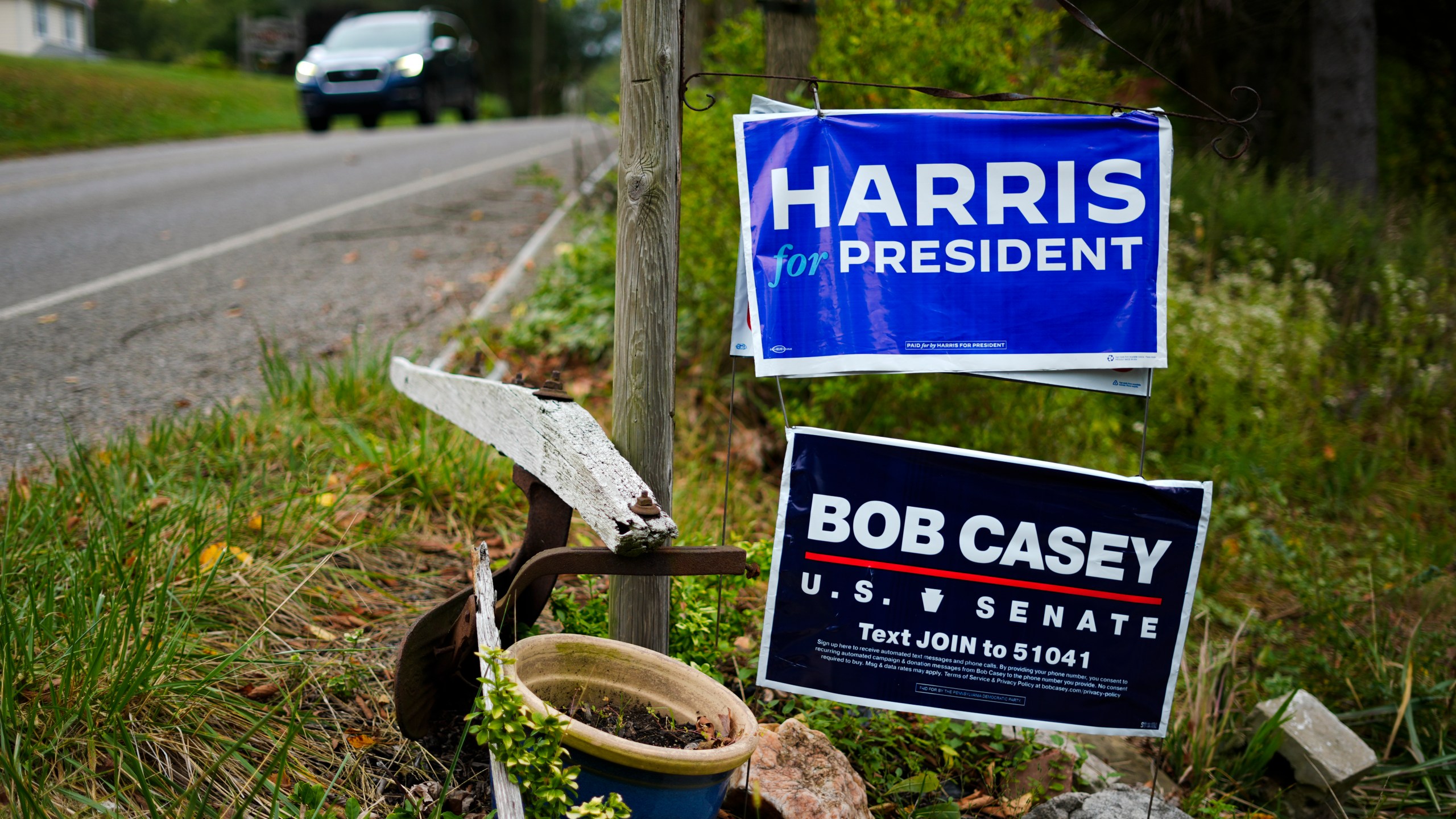 A car passes signs supporting Democratic presidential nominee Vice President Kamala Harris and Sen. Bob Casey, D-Pa., in Butler, Friday, Sept. 27, 2024. (AP Photo/Matt Rourke)