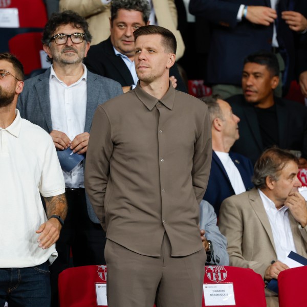 Wojciech Szczesny, centre, a new goalkeeper for Barcelona is on stands during the Champions League soccer match between Barcelona and Young Boys at the Lluis Companys Olympic Stadium in Barcelona, Spain, Tuesday, Oct. 1, 2024. (AP Photo/Joan Monfort)