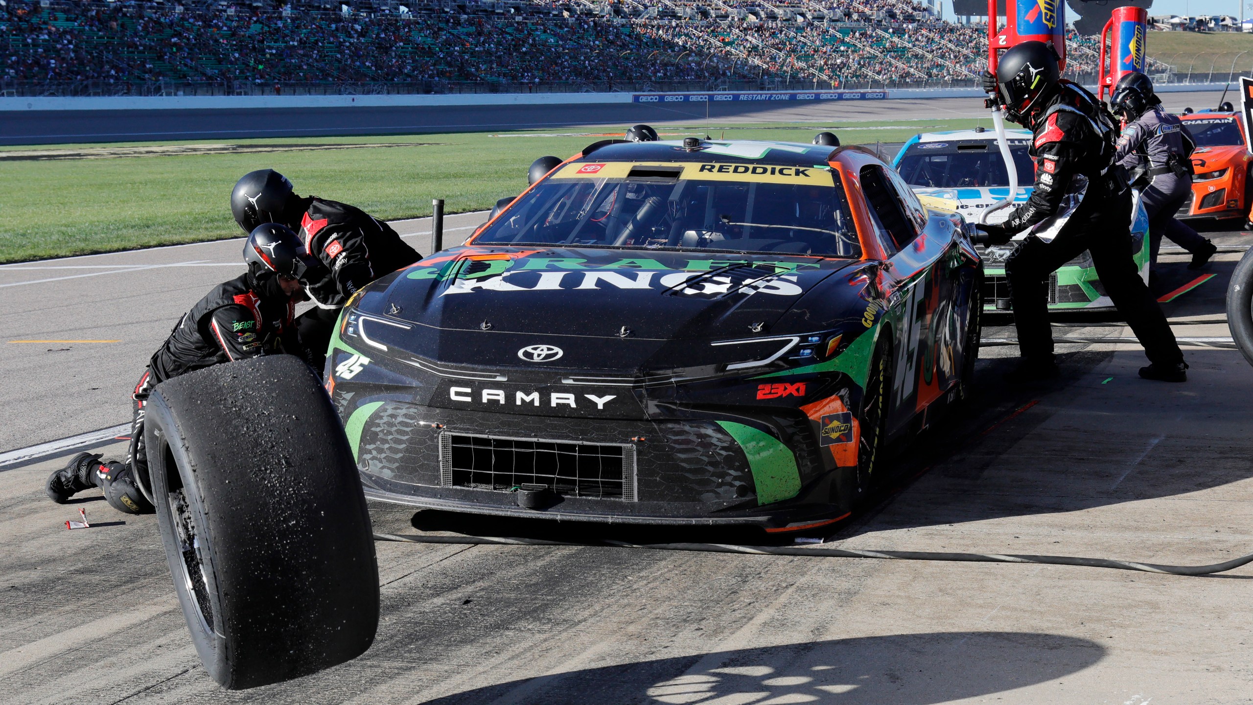 Tyler Reddick (45) has his tires changed on pit road during a NASCAR Cup Series auto race at Kansas Speedway in Kansas City, Kan., Sunday, Sept. 29, 2024. (AP Photo/Colin E. Braley)