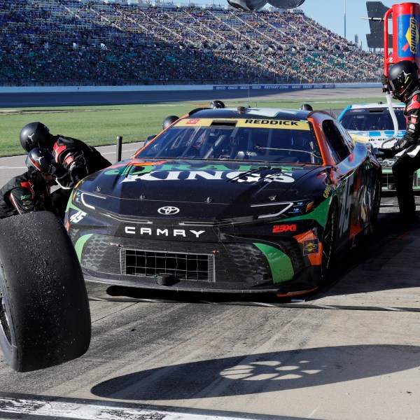 Tyler Reddick (45) has his tires changed on pit road during a NASCAR Cup Series auto race at Kansas Speedway in Kansas City, Kan., Sunday, Sept. 29, 2024. (AP Photo/Colin E. Braley)