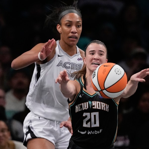 New York Liberty's Sabrina Ionescu (20) passes away from Las Vegas Aces' A'ja Wilson (22) during the second half of a WNBA basketball semifinal game, Tuesday, Oct. 1, 2024, in New York. The Liberty won 88-84. (AP Photo/Frank Franklin II)