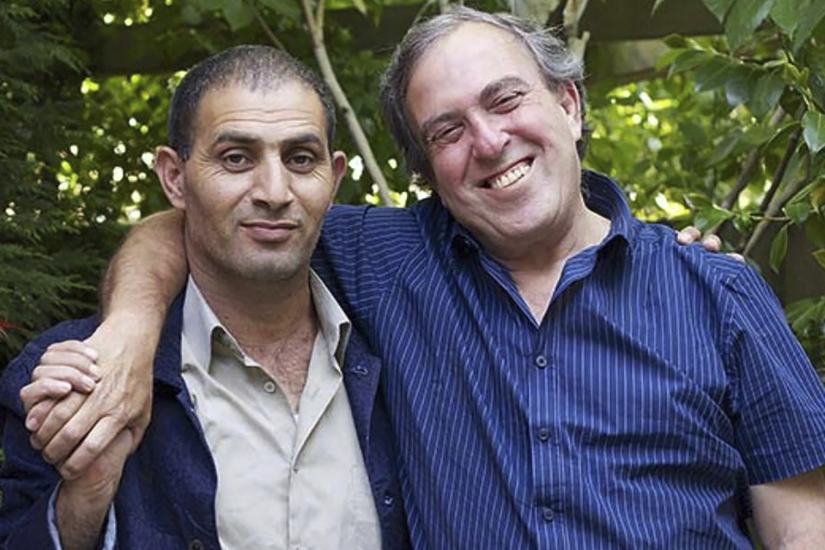 This undated photo provided by Peter Singer shows from left, Bassam Aramin and Rami Elhanan. (Peter Singer via AP)