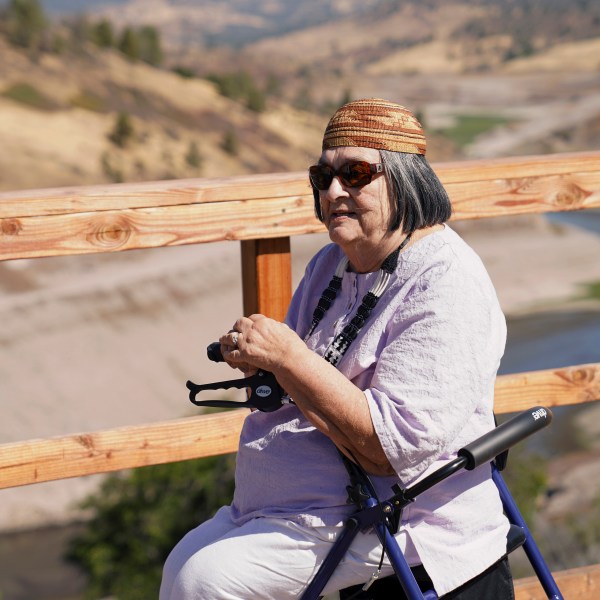 In this image provided by Matthew Johan Mais, Yurok elder Jacqueline Winter poses for a photo near the Klamath River on Aug. 25, 2024, near Hornbrook, Calif. (Matthew Johan Mais via AP)