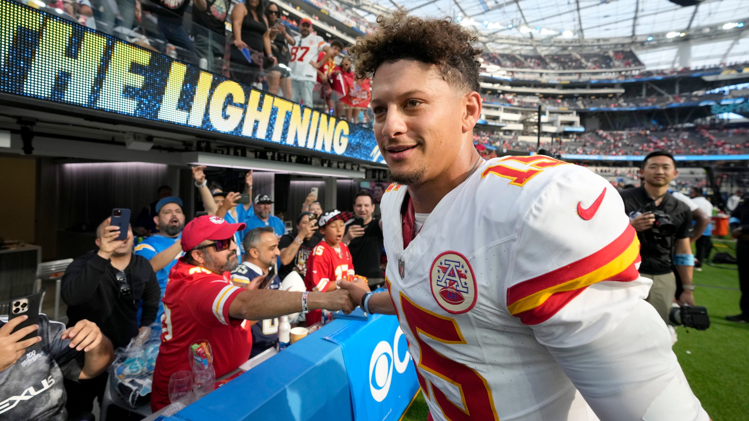 Kansas City Chiefs quarterback Patrick Mahomes fist bumps fans as he heads off the field following an NFL football game against the Los Angeles Chargers Sunday, Sept. 29, 2024, in Inglewood, Calif. The Chiefs won 17-10. (AP Photo/Marcio Jose Sanchez)