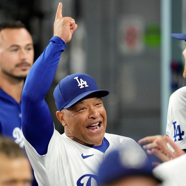 Los Angeles Dodgers manager Dave Roberts gestures to teammates prior to a baseball game against the San Diego Padres, Tuesday, Sept. 24, 2024, in Los Angeles. (AP Photo/Mark J. Terrill)