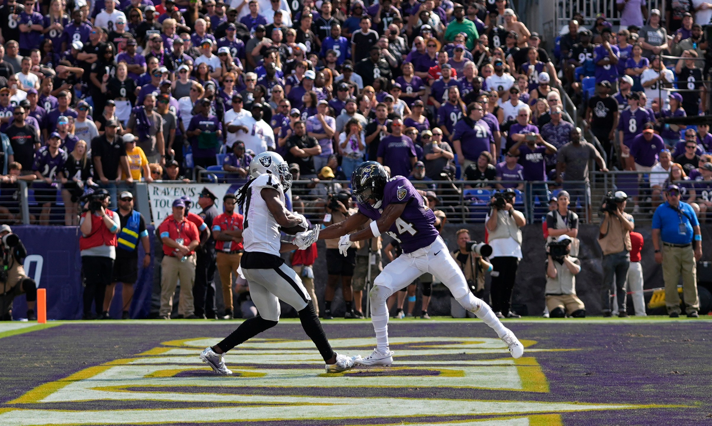 Las Vegas Raiders wide receiver Davante Adams, left, catches a touchdown pass against Baltimore Ravens cornerback Marlon Humphrey (44) during the second half of an NFL football game, Sunday, Sept. 15, 2024, in Baltimore. (AP Photo/Stephanie Scarbrough)