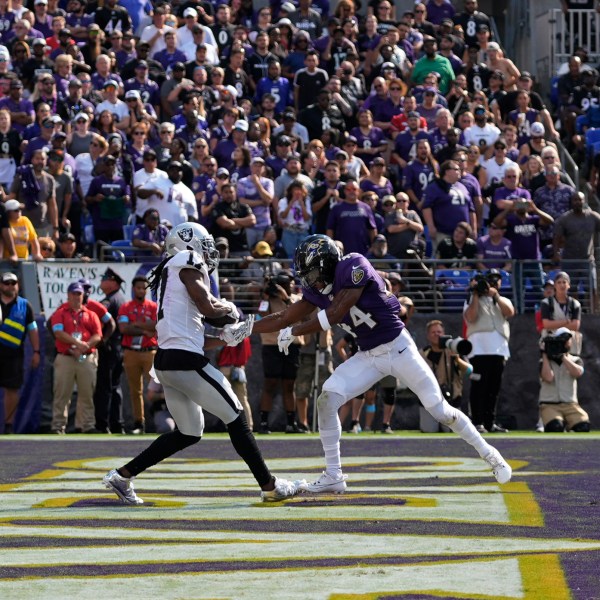 Las Vegas Raiders wide receiver Davante Adams, left, catches a touchdown pass against Baltimore Ravens cornerback Marlon Humphrey (44) during the second half of an NFL football game, Sunday, Sept. 15, 2024, in Baltimore. (AP Photo/Stephanie Scarbrough)