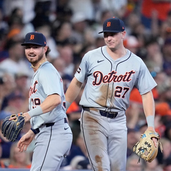 Detroit Tigers third baseman Zach McKinstry (39) and shortstop Trey Sweeney (27) celebrate after completing a double play that off a ground ball by Houston Astros' Yainer Diaz in the sixth inning of Game 2 of an AL Wild Card Series baseball game Wednesday, Oct. 2, 2024, in Houston. (AP Photo/Kevin M. Cox)