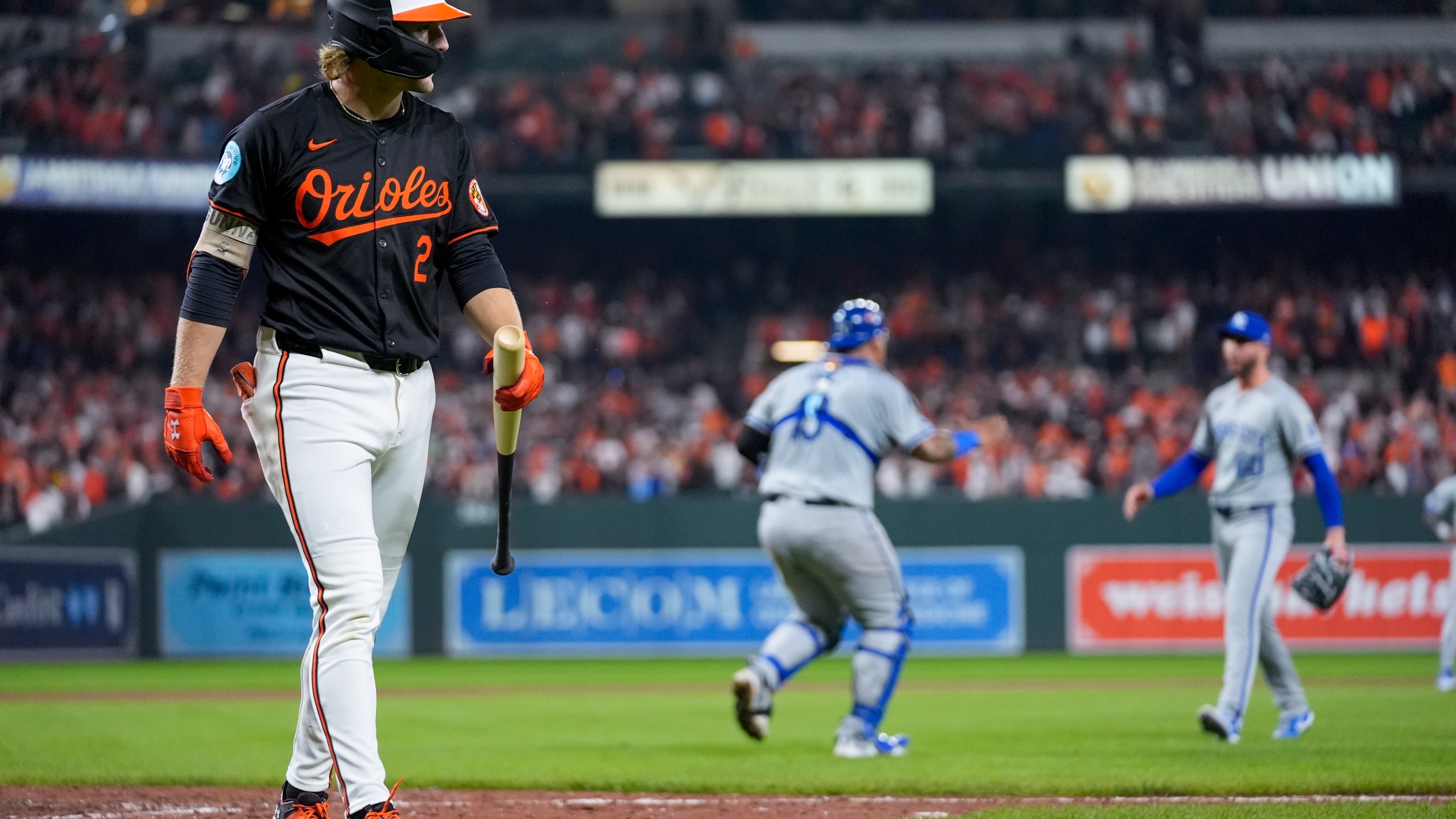 Baltimore Orioles' Gunnar Henderson, left, walks to the dugout after striking out for the final out as Kansas City Royals pitcher Lucas Erceg, right, and catcher Salvador Perez react following Game 2 of an AL Wild Card Series baseball game, Wednesday, Oct. 2, 2024 in Baltimore. The Royals won 2-1. (AP Photo/Stephanie Scarbrough)