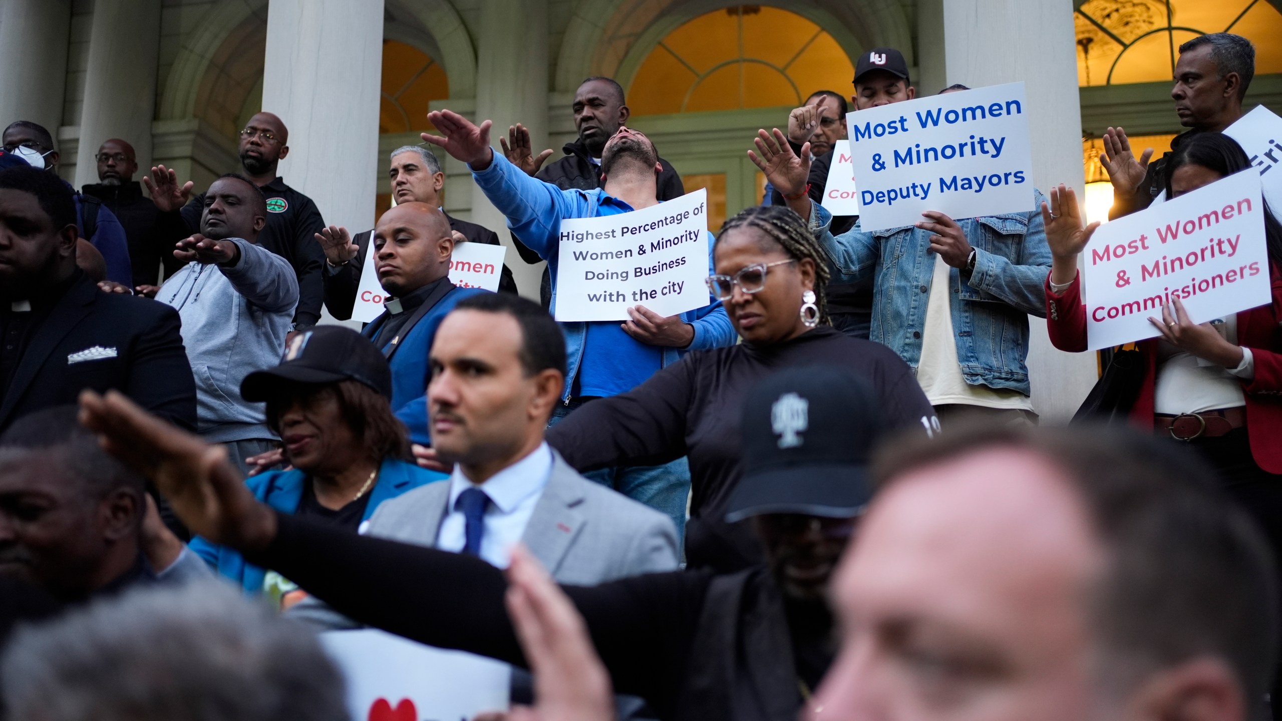 Faith leaders and other supporters pray over New York City Mayor Eric Adams during a rally and prayer vigil on the steps of City Hall in New York, Tuesday, Oct. 1, 2024. (AP Photo/Seth Wenig)