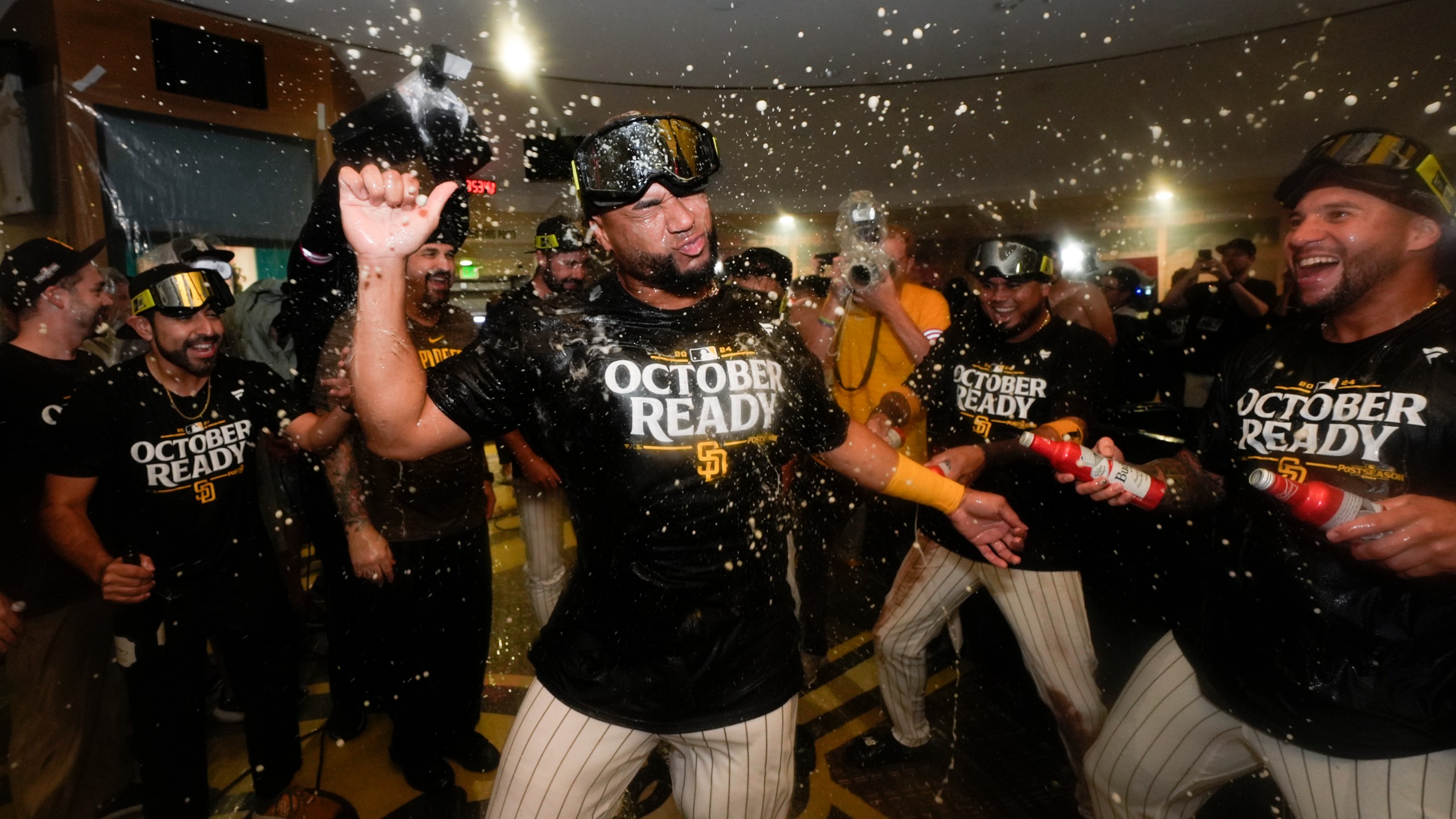 San Diego Padres players celebrate in the dugout after defeating the Atlanta Braves in Game 2 of an NL Wild Card Series baseball game Wednesday, Oct. 2, 2024, in San Diego. (AP Photo/Gregory Bull)