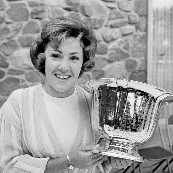 FILE - Susie Maxwell holds the silver trophy after winning the 36th annual Women's Western golf tournament, June 14, 1965, in Chicago. (AP Photo/Larry Stoddard, File)