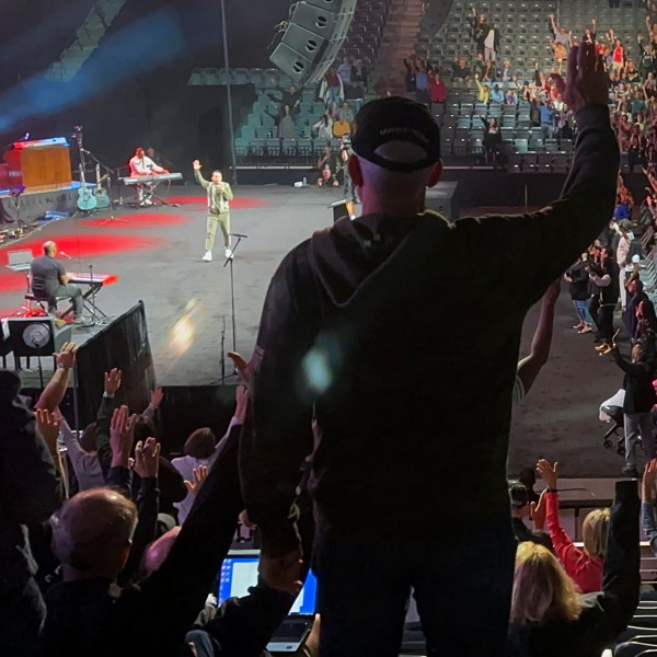 Audience members raise their hands in agreement with speaker Samuel Rodriguez, lead pastor of New Season church in Sacramento, Calif., at the Opening the Heavens conference on Friday, Sept. 13, 2024, at the Mid-America Center in Council Bluffs, Iowa. (AP Photo/Peter Smith)