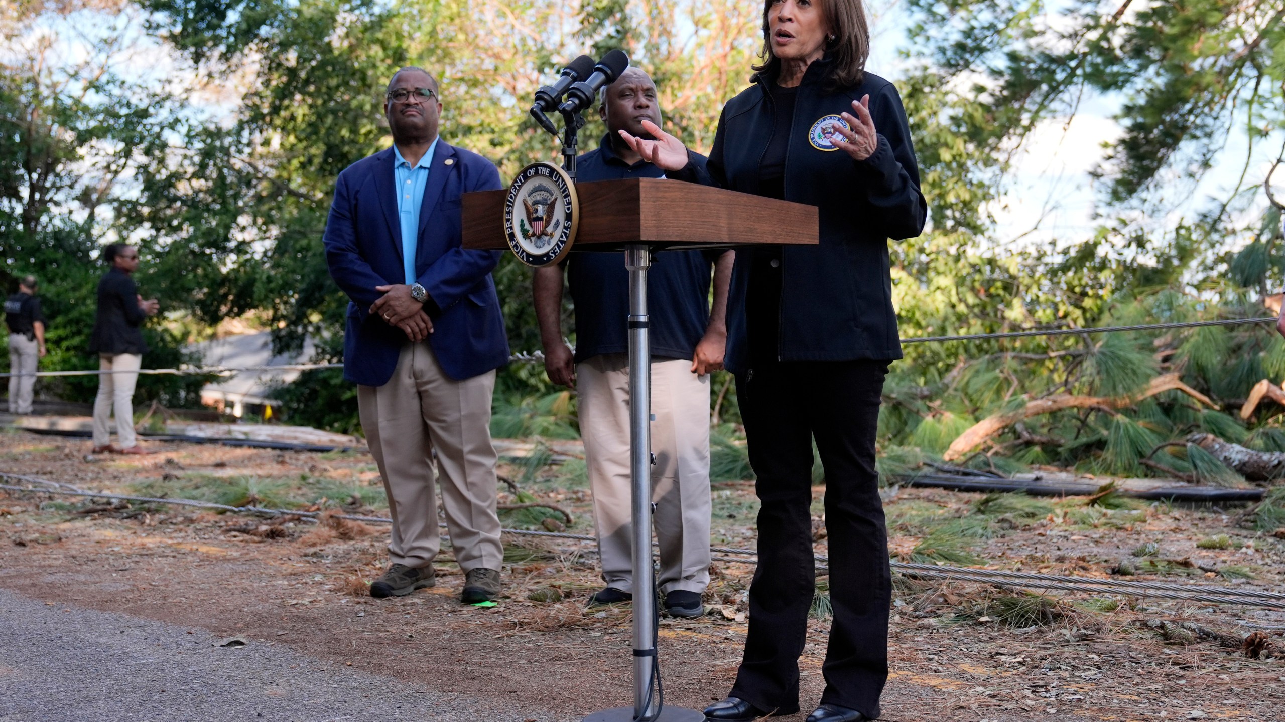 Democratic presidential nominee Vice President Kamala Harris speaks as she tours an area impacted by Hurricane Helene in Augusta, Ga., Wednesday, Oct. 2, 2024, as Augusta Mayor Garnett Johnson, left, and FEMA deputy administrator Erik Hooks listen. (AP Photo/Carolyn Kaster)