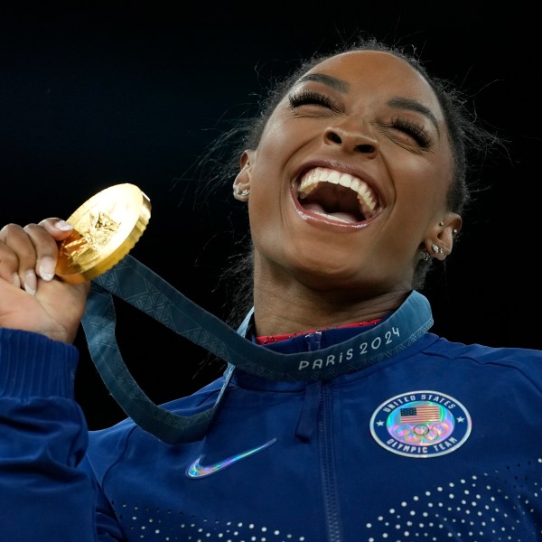 FILE - Simone Biles, of the United States, celebrates winning the gold medal during the medal ceremony in the women's artistic gymnastics individual vault finals at Bercy Arena at the 2024 Summer Olympics, Aug. 3, 2024, in Paris, France. (AP Photo/Francisco Seco, File)