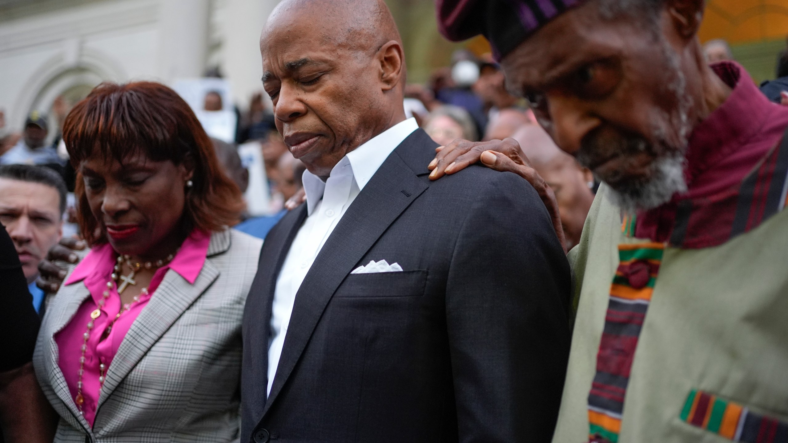 Faith leaders and other supporters pray over New York City Mayor Eric Adams, center, during a rally and prayer vigil on the steps of City Hall in New York, Tuesday, Oct. 1, 2024. (AP Photo/Seth Wenig)