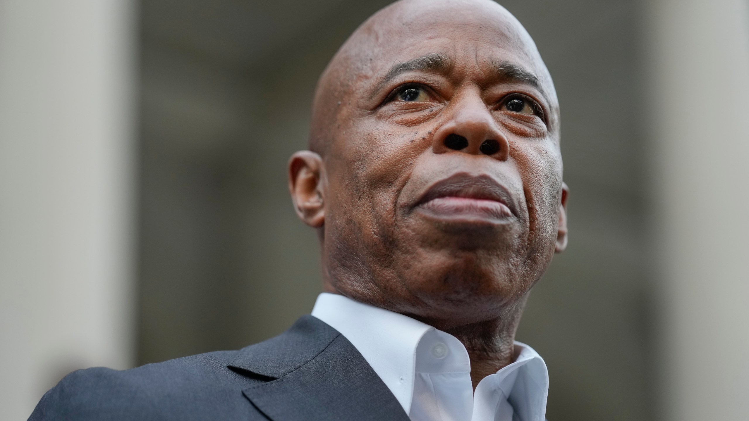 New York City Mayor Eric Adams looks on while surrounded by faith leaders and other supporters during a rally and prayer vigil on the steps of City Hall in New York, Tuesday, Oct. 1, 2024. (AP Photo/Seth Wenig)