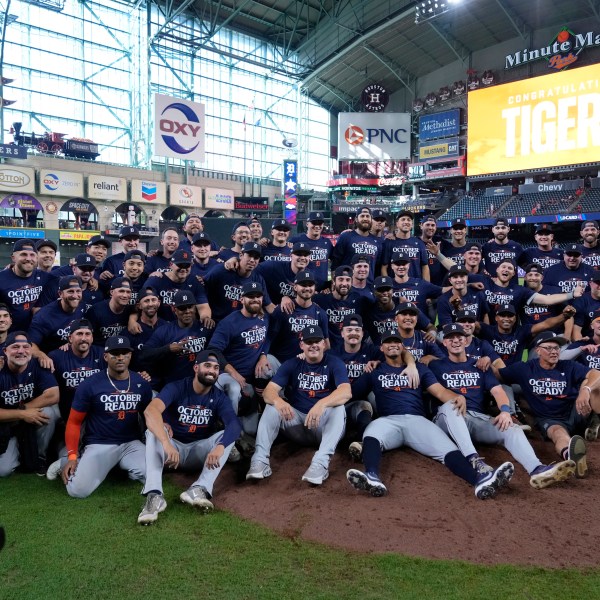 The Detroit Tigers pose for a team photo after their 5-2 win against the Houston Astros in Game 2 of an AL Wild Card Series baseball game Wednesday, Oct. 2, 2024, in Houston. (AP Photo/Kevin M. Cox)