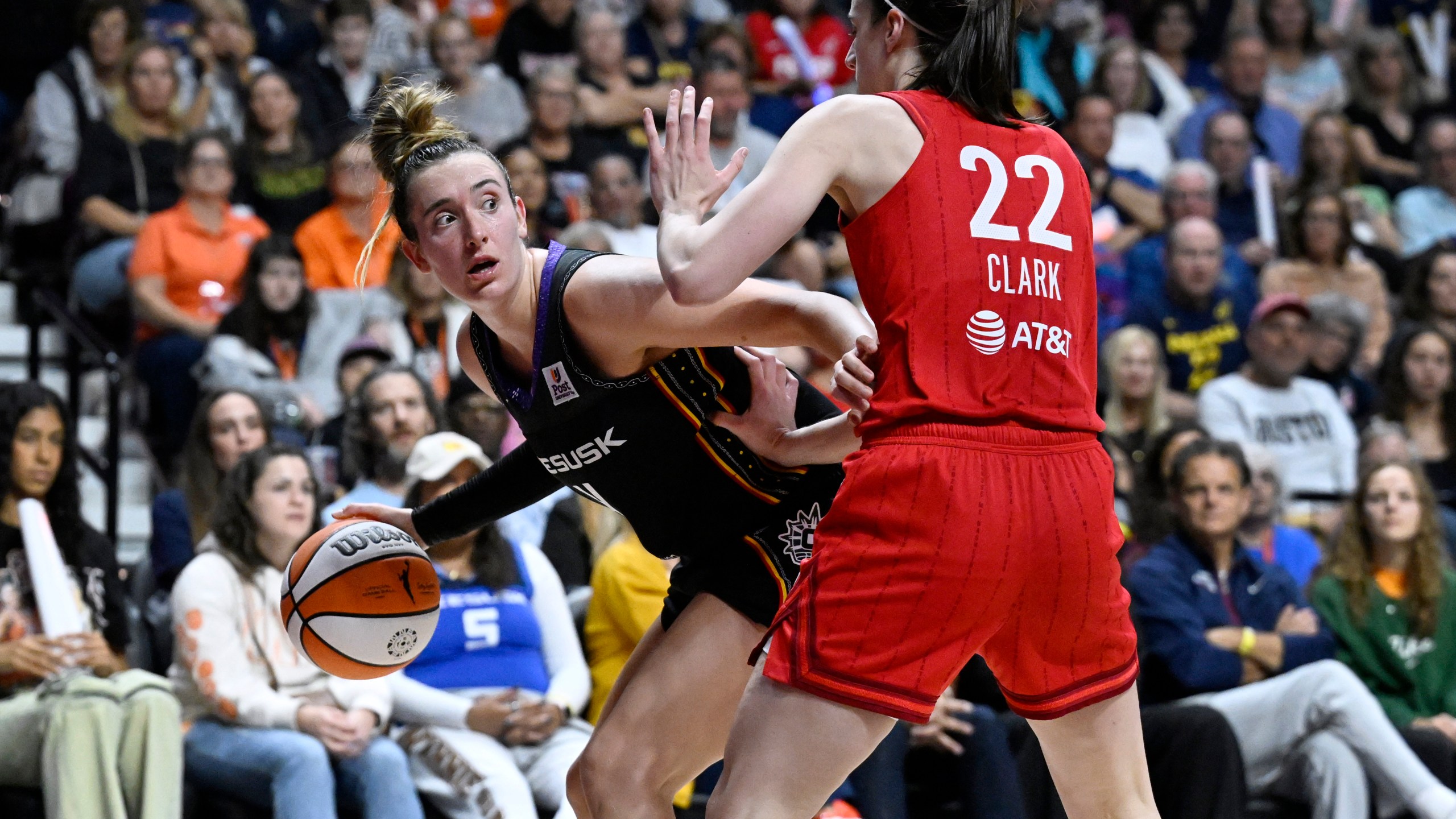 Connecticut Sun guard Marina Mabrey, left, is guarded by Indiana Fever guard Caitlin Clark during the second half of a first-round WNBA basketball playoff game, Wednesday, Sept. 25, 2024, in Uncasville, Conn. (AP Photo/Jessica Hill)