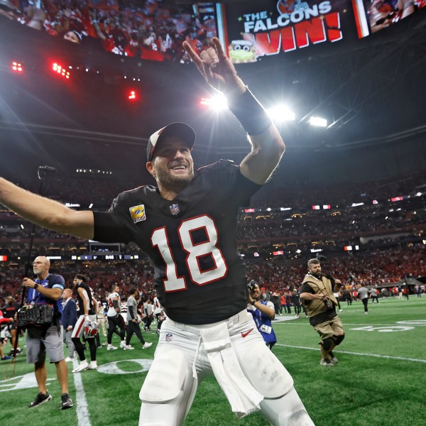 Atlanta Falcons quarterback Kirk Cousins (18) celebrates with the fans after the team defeated the Tampa Bay Buccaneers during overtime in an NFL football game Thursday, Oct. 3, 2024, in Atlanta. (AP Photo/Butch Dill)