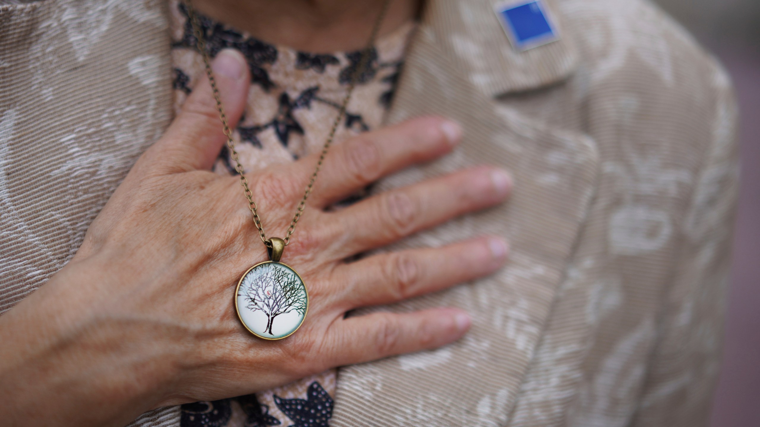 Audrey Glickman, a Tree of Life member who survived the 2018 attack, holds a necklace representing the synagogue, Friday, Sept. 27, 2024, in Pittsburgh. (AP Photo/Jessie Wardarski)