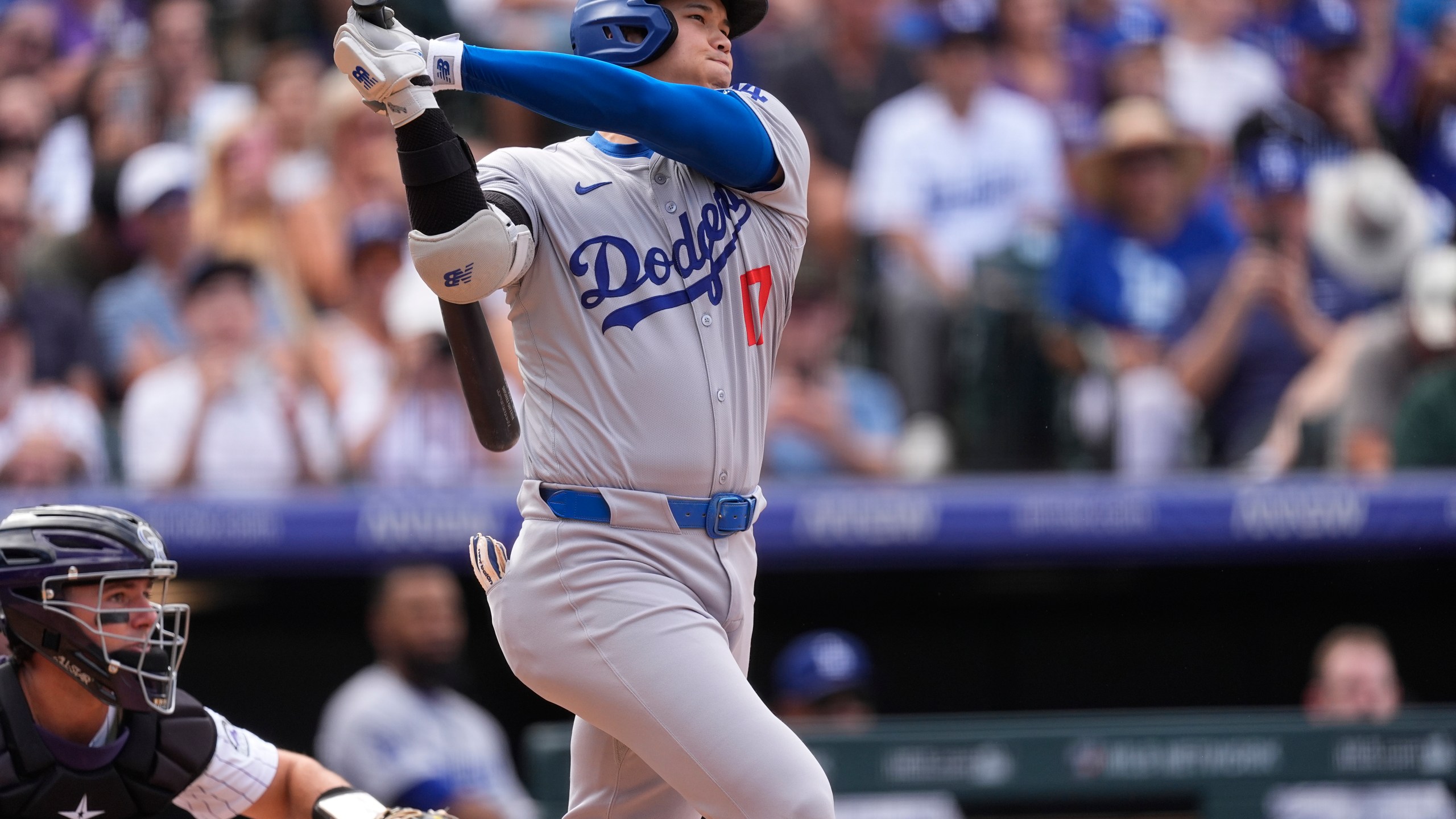 Los Angeles Dodgers' Shohei Ohtani follows the flight of his single off Colorado Rockies pitcher Seth Halvorsen in the eighth inning of a baseball game Sunday, Sept. 29, 2024, in Denver. (AP Photo/David Zalubowski)