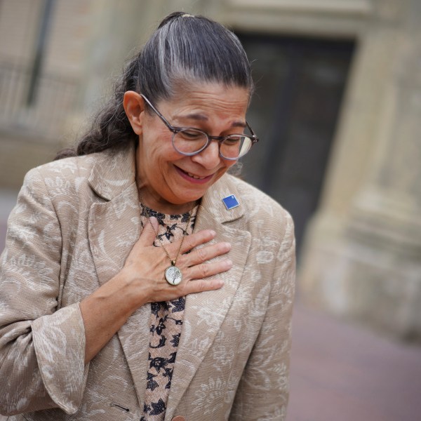 Audrey Glickman, a Tree of Life member who survived the 2018 attack, holds a necklace representing the synagogue, Friday, Sept. 27, 2024, in Pittsburgh. (AP Photo/Jessie Wardarski)