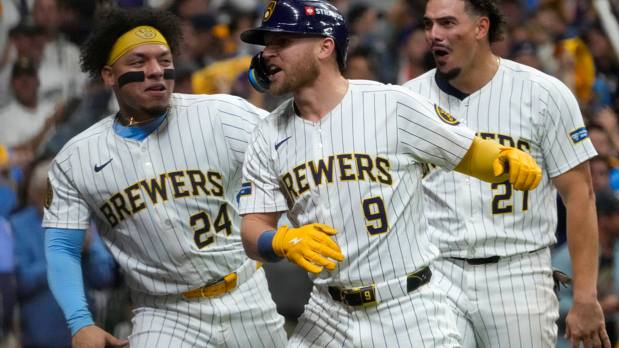 Milwaukee Brewers' Jake Bauers celebrates his home run with William Contreras (24) and Willy Adames (27) during the seventh inning of Game 3 of a National League wild card baseball game against the New York Mets Thursday, Oct. 3, 2024, in Milwaukee. (AP Photo/Morry Gash)