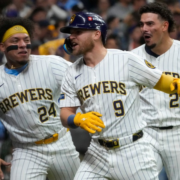 Milwaukee Brewers' Jake Bauers celebrates his home run with William Contreras (24) and Willy Adames (27) during the seventh inning of Game 3 of a National League wild card baseball game against the New York Mets Thursday, Oct. 3, 2024, in Milwaukee. (AP Photo/Morry Gash)