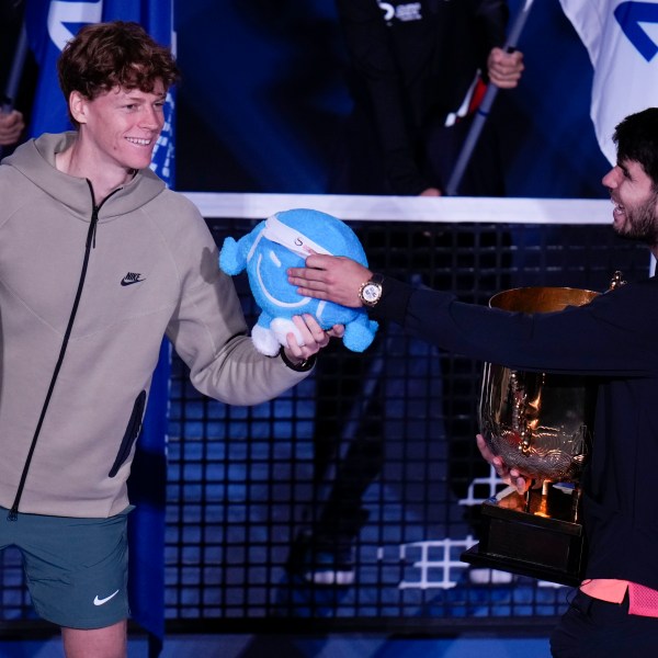 Carlos Alcaraz, right, of Spain talks with runner-up Jannik Sinner of Italy after winning their men's singles finals match of the China Open tennis tournament, at the National Tennis Center in Beijing, Wednesday, Oct. 2, 2024.(AP Photo/Andy Wong)