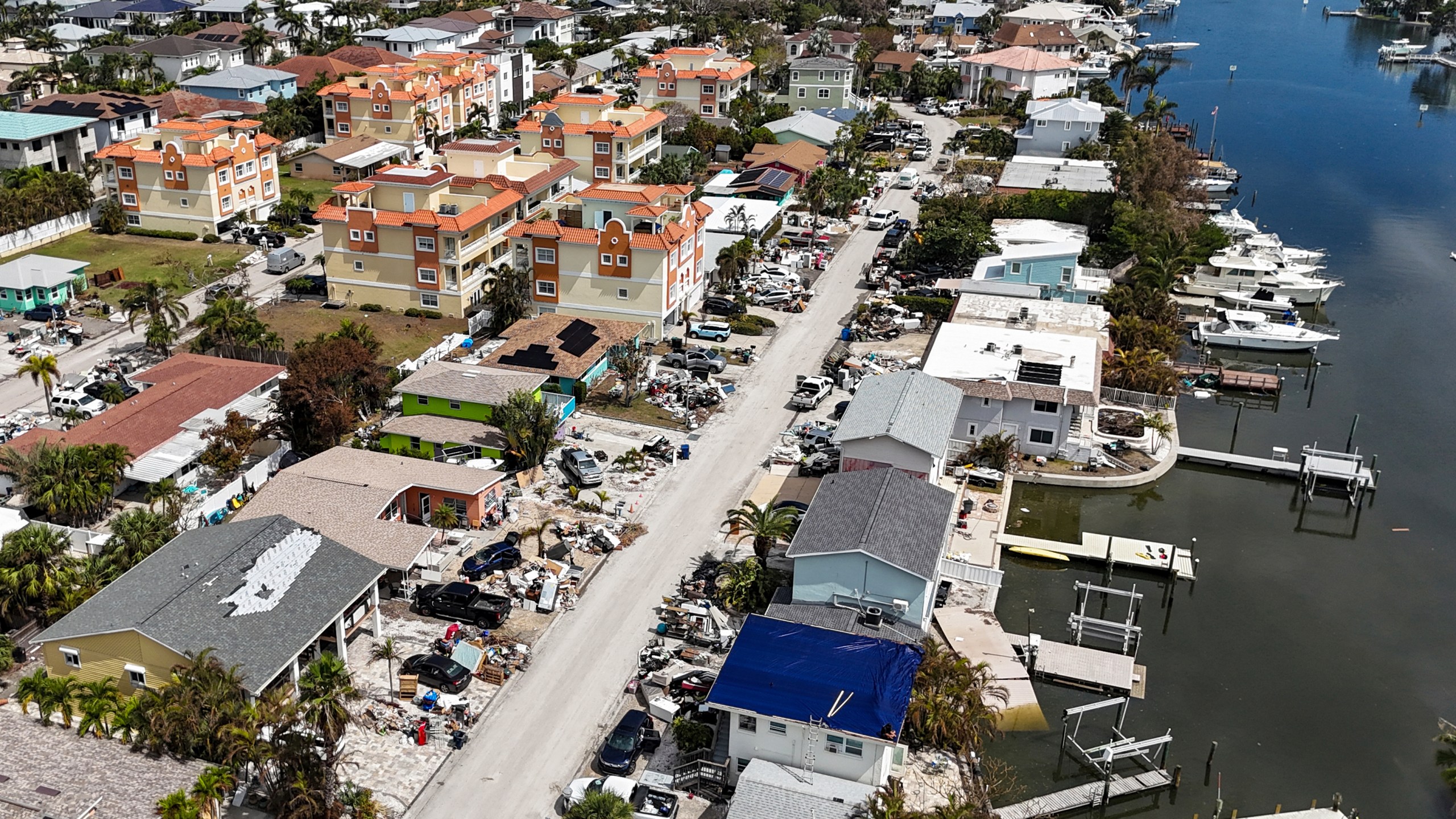 Contents of homes line the streets after flooding from Hurricane Helene on Wednesday, Oct. 2, 2024, in Reddington Shores, Fla. (AP Photo/Mike Carlson)