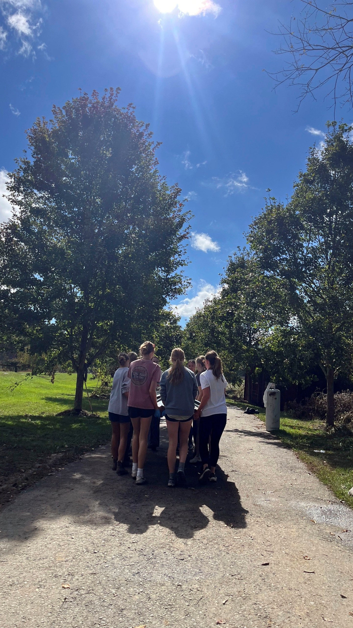 In this photo provided by Mary Walker, members of the girls cross country team at Watauga High School perform cleanup duties Wednesday, Oct. 2, 2024, along the Greenway Trail in Boone, N.C.. The area was hit hard by Hurricane Helene. (Mary Walker via AP)