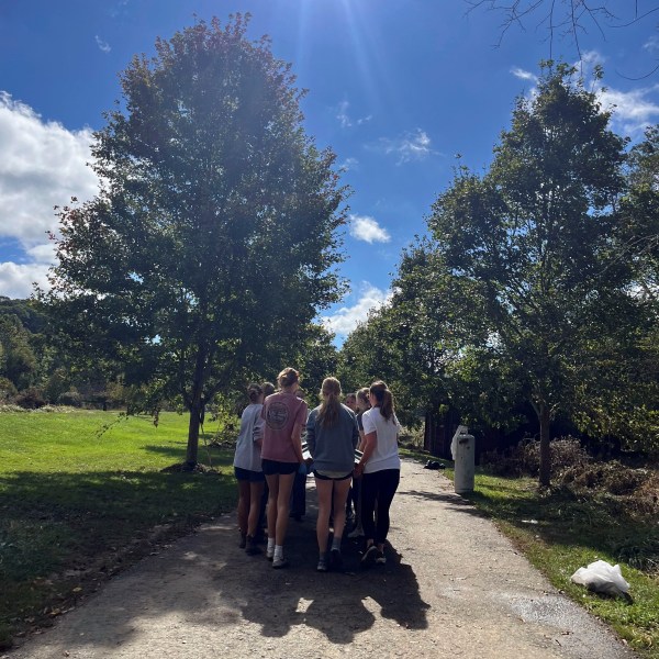 In this photo provided by Mary Walker, members of the girls cross country team at Watauga High School perform cleanup duties Wednesday, Oct. 2, 2024, along the Greenway Trail in Boone, N.C.. The area was hit hard by Hurricane Helene. (Mary Walker via AP)