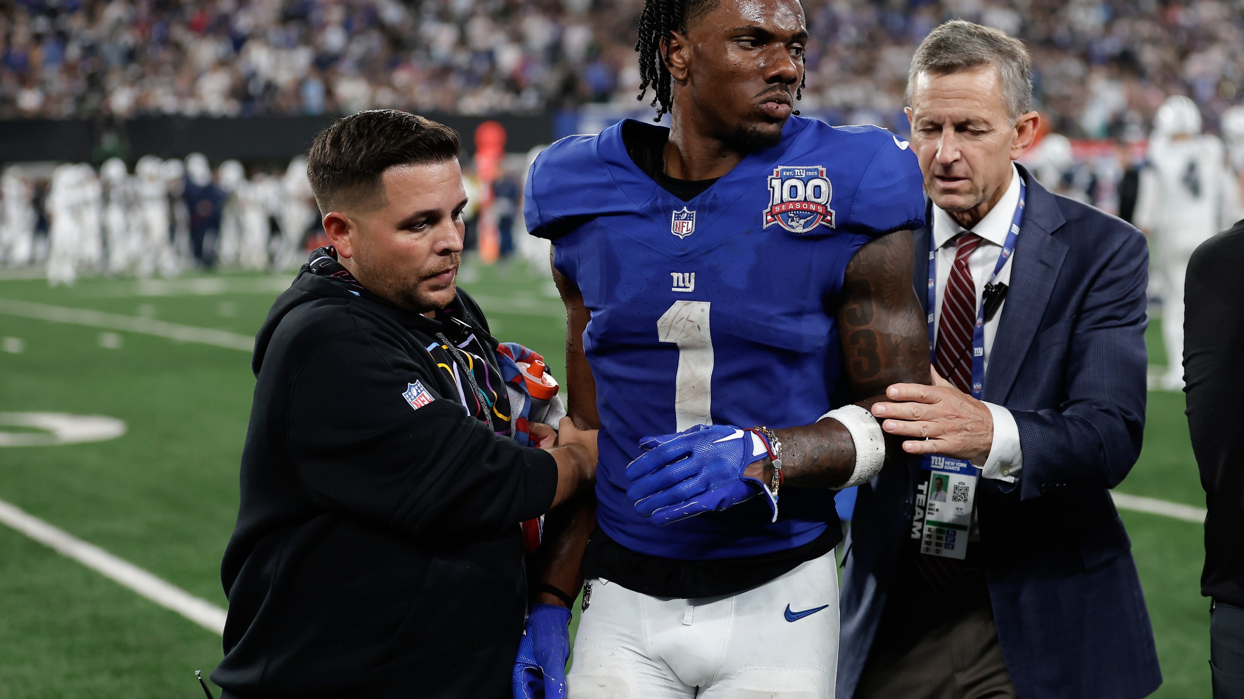 New York Giants wide receiver Malik Nabers (1) is helped off the field after an injury during the fourth quarter of an NFL football game against the Dallas Cowboys, Thursday, Sept. 26, 2024, in East Rutherford, N.J. (AP Photo/Adam Hunger)