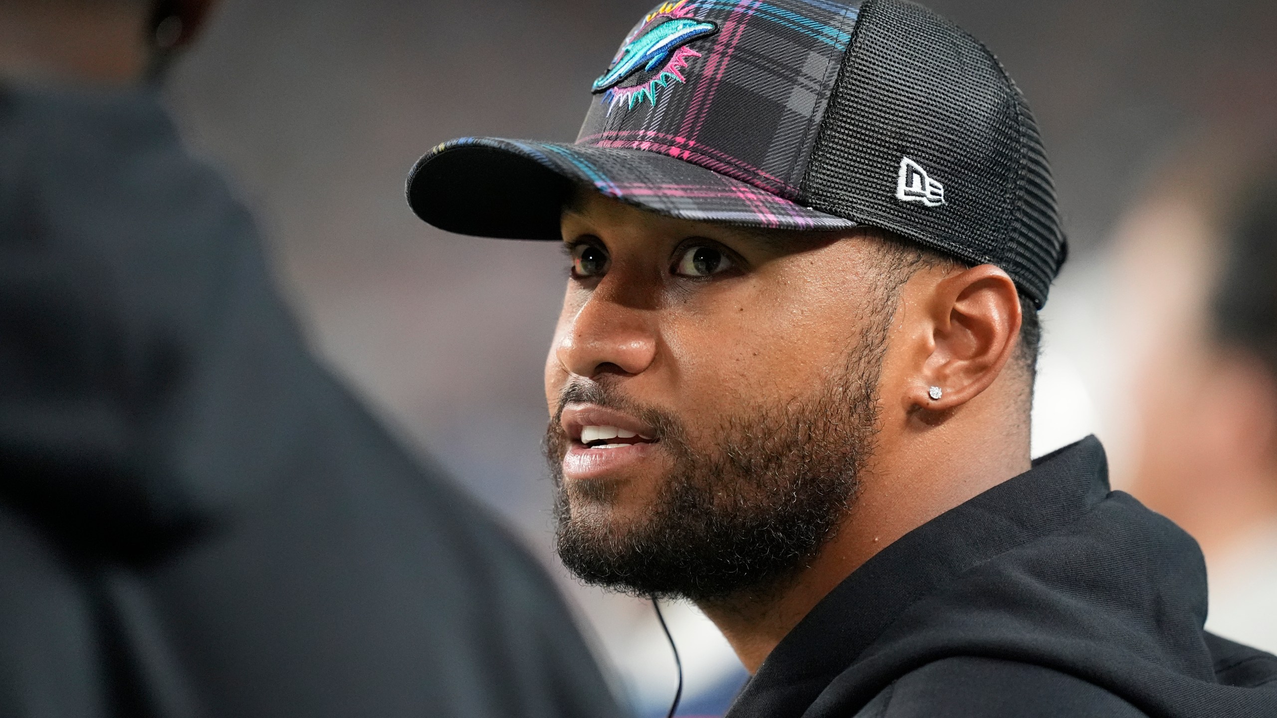 Miami Dolphins quarterback Tua Tagovailoa talks on the sidelines during the second half of an NFL football game against the Tennessee Titans, Monday, Sept. 30, 2024, in Miami Gardens, Fla. (AP Photo/Rebecca Blackwell)