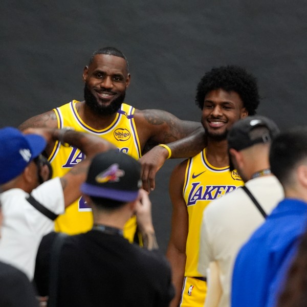 Los Angeles Lakers' LeBron James, left, and his son, Bronny James, pose for photos during the NBA basketball team's media day in El Segundo, Calif., Monday, Sept. 30, 2024. (AP Photo/Jae C. Hong)